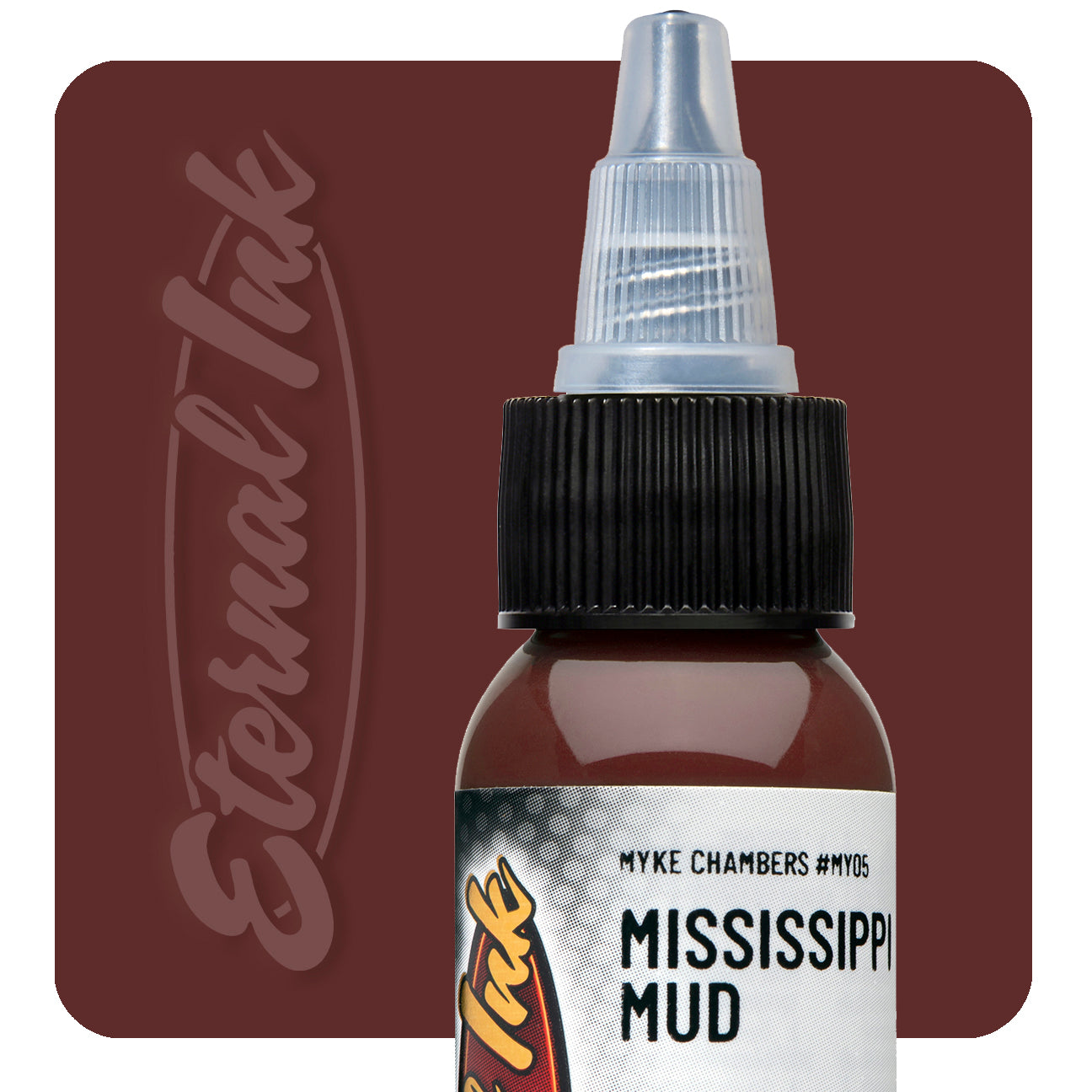 Bottle of tattoo ink labeled 'Mississippi Mud' with 'Eternal Ink' branding on a brown background.