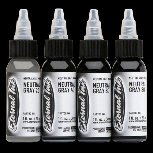 Four bottles of Eternal Ink neutral gray tattoo ink on a white background